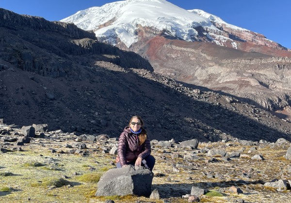Cal State LA Professor Jennifer Garrison sits in front of a large mountain.