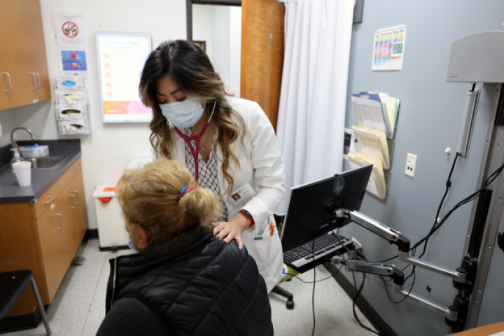 Student helping patient.