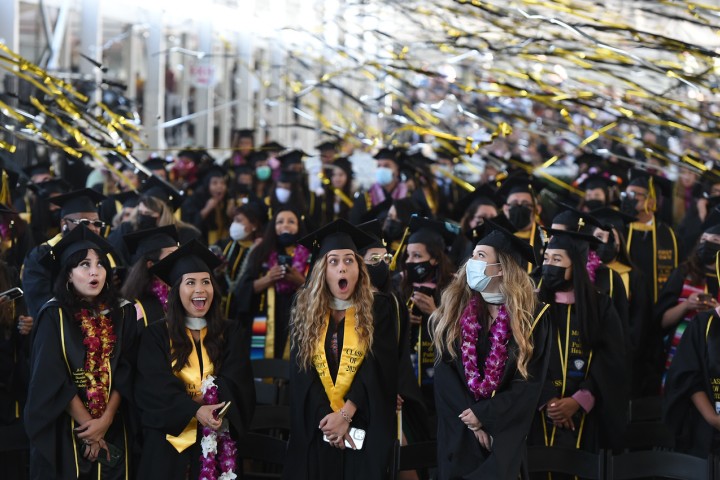 Students smiling at commencement.