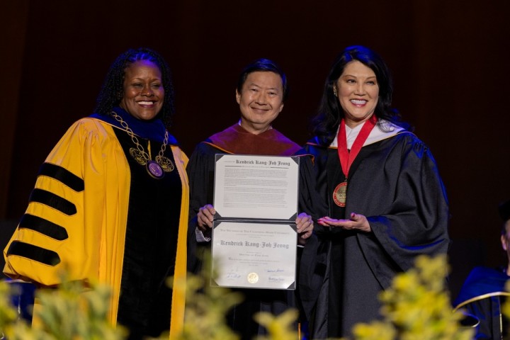 President Berenecea Johnson Eanes joins honorees on stage during the presentation of an honorary degree at Cal State LA’s 2025 commencement ceremony.
