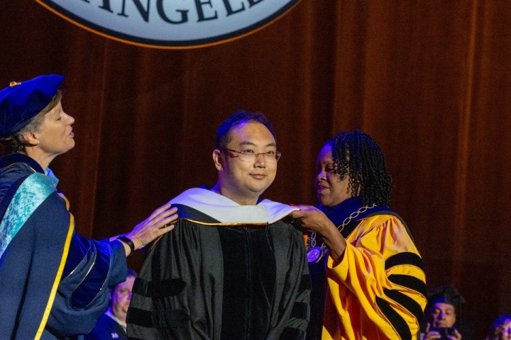 Cal State LA President Berenecea Johnson Eanes hoods an honorary degree recipient during the 2025 commencement ceremony.